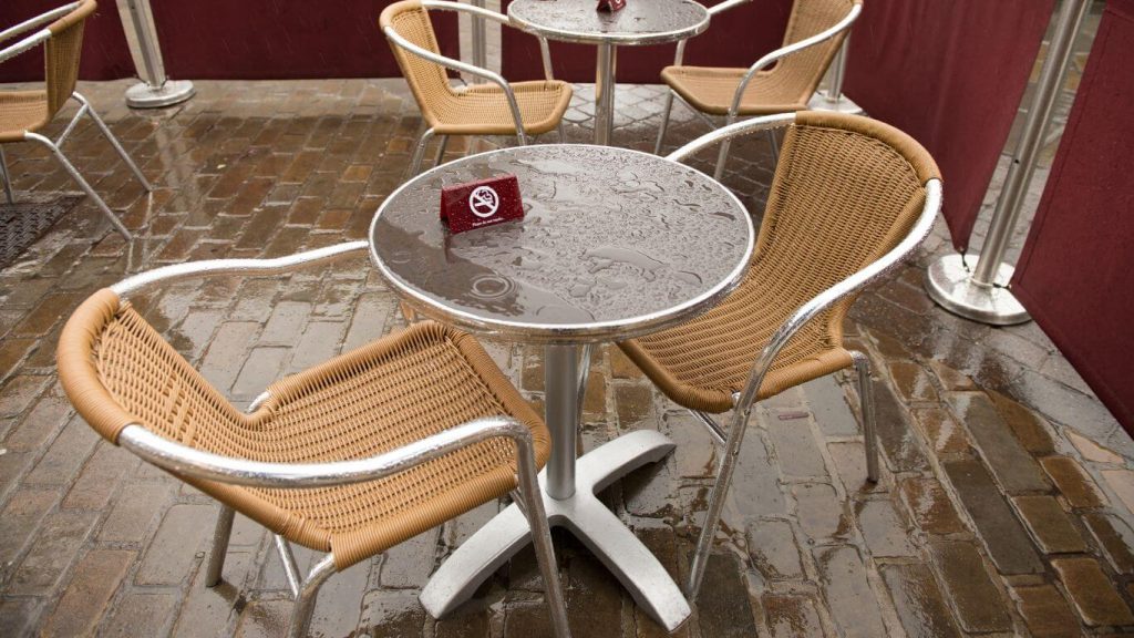 A wet outdoor bistro table on the rain